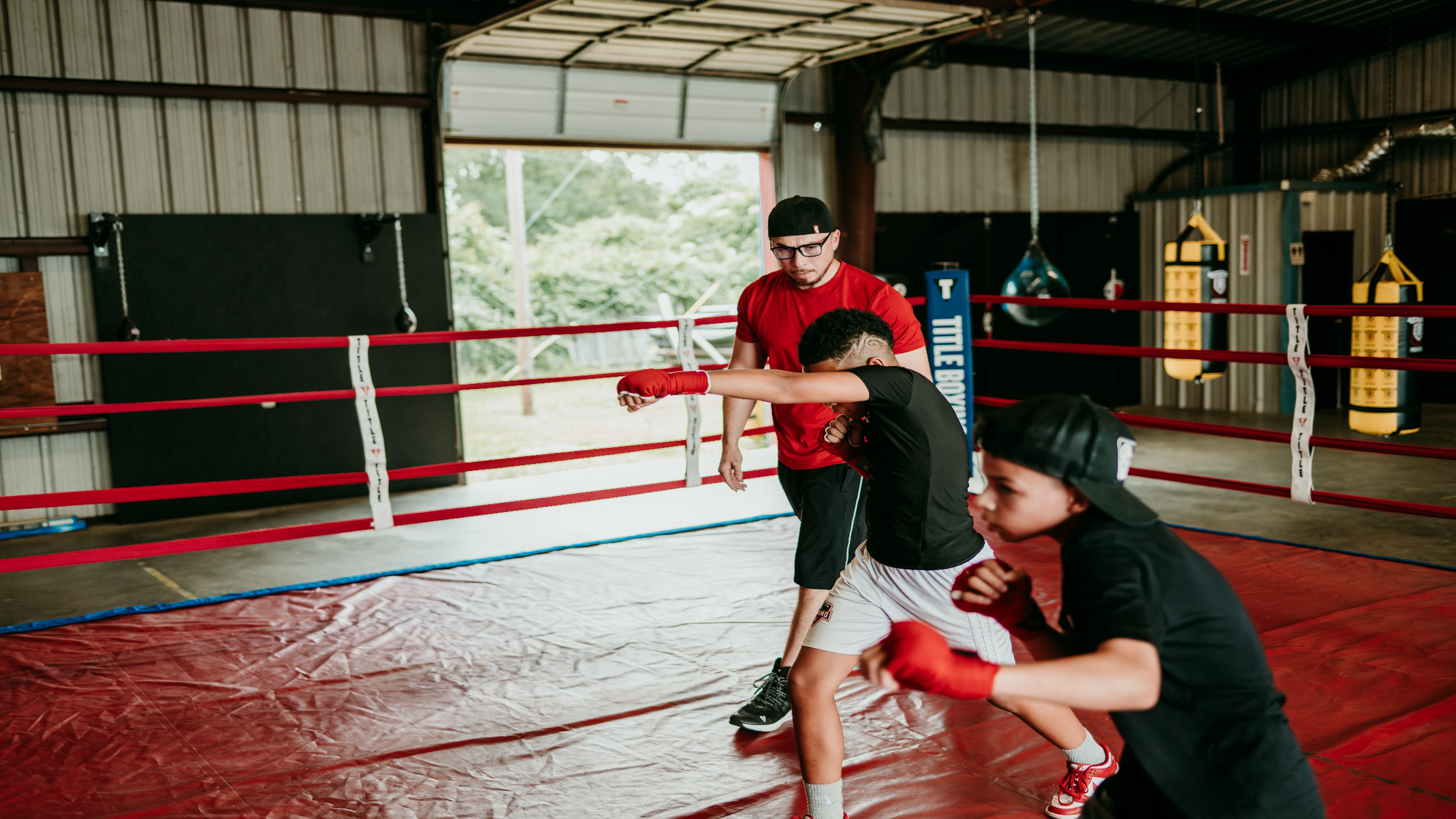 Coach working with young boxers inside the ring
