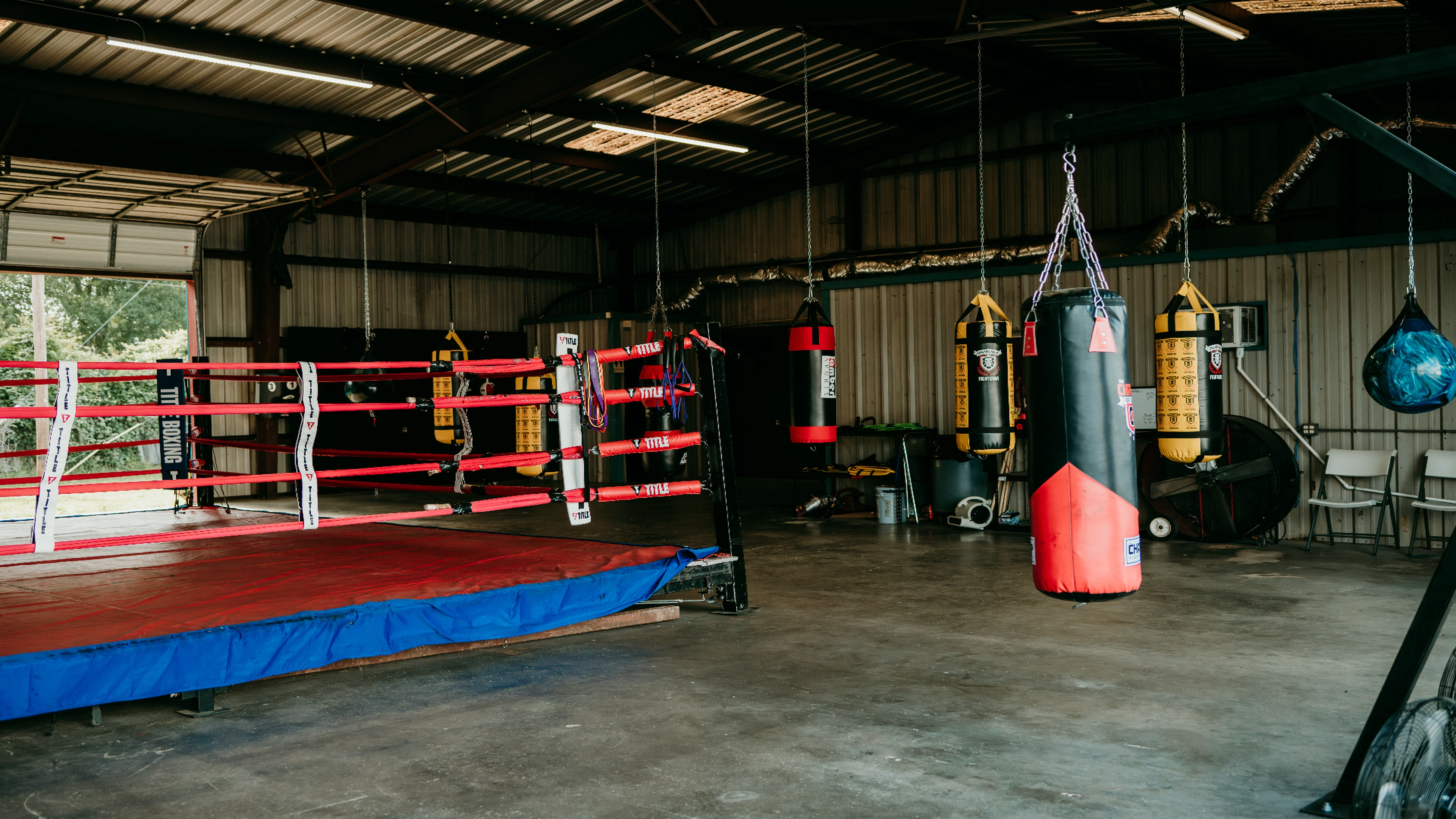 Boxing ring and heavy bags inside One More Round Boxing Gym