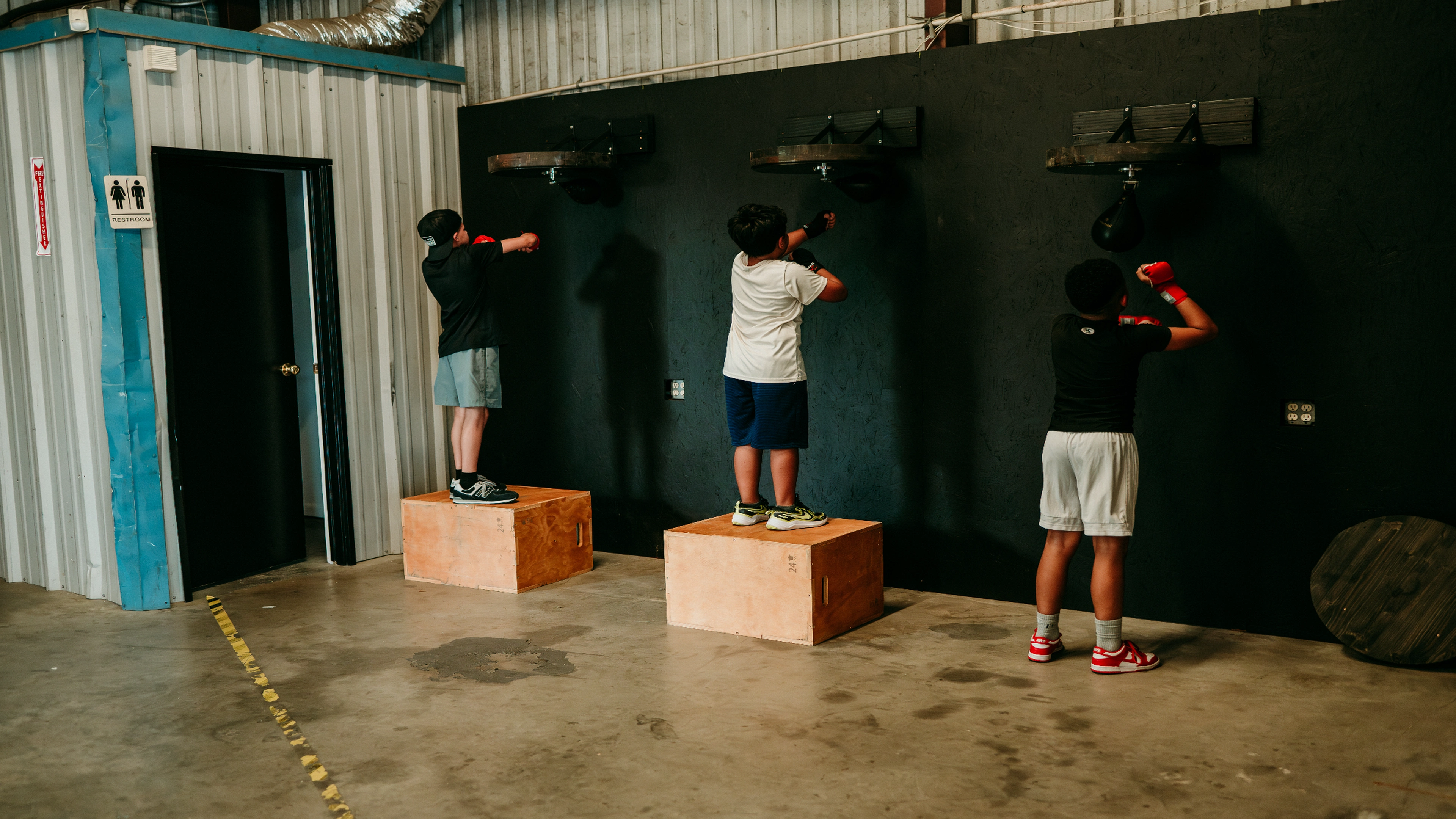 Youth boxers training on speed bag platforms