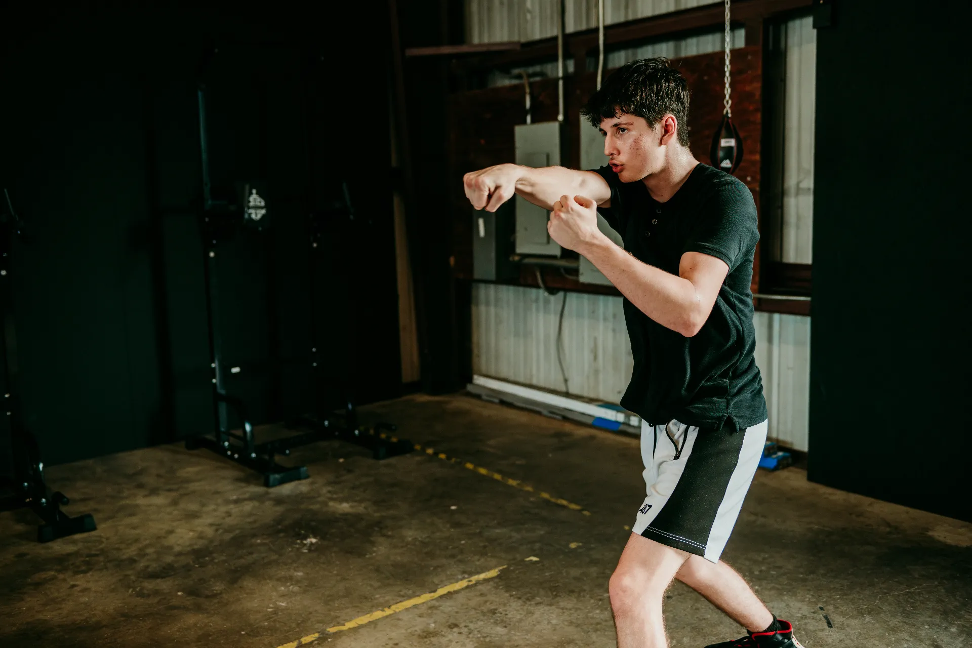Boxer throwing a cross during a shadowboxing drill at One More Round Boxing Gym