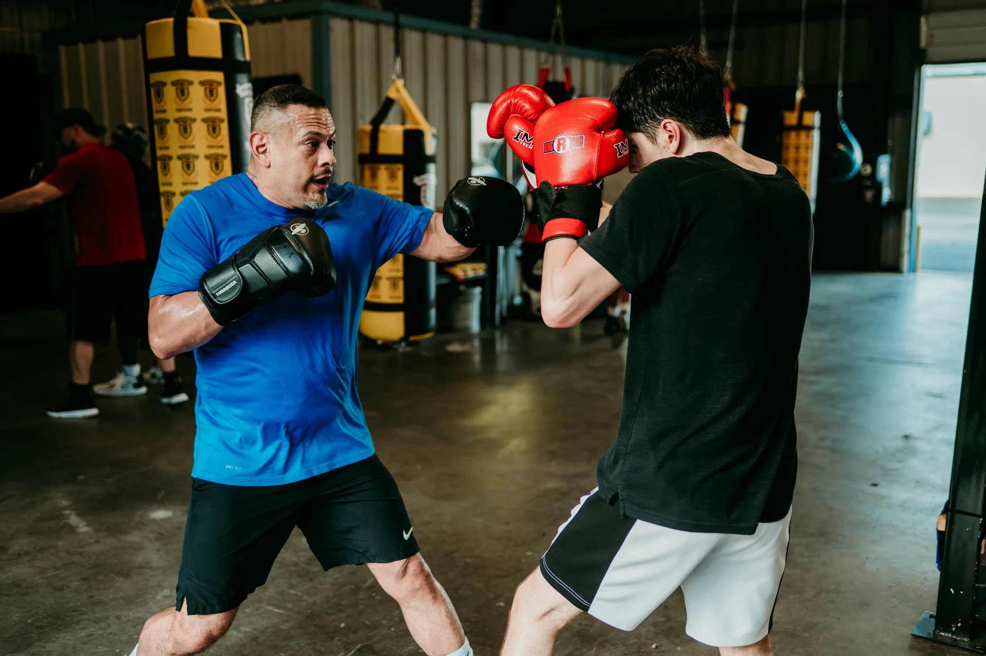 Coach Romo demonstrating striking fundamentals with a student