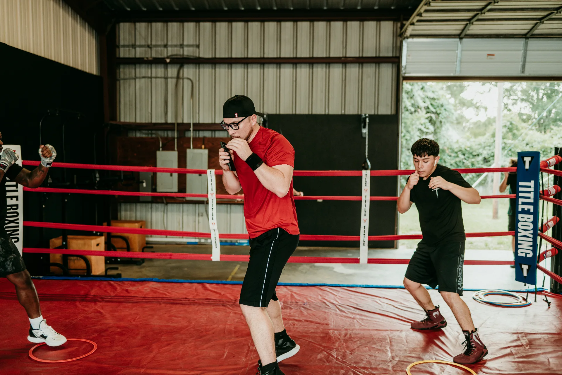 Boxers shadowboxing in the ring at One More Round Boxing Gym in Tomball, Texas